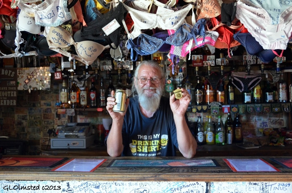 Ronnie holds beer & Junior Ranger badge Ronnies Sex Shop Route 62 Barrydale South Africa