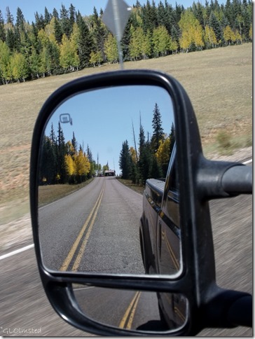 Fall colors & entrance station in side mirror SR67 Kaibab National Forest Arizona
