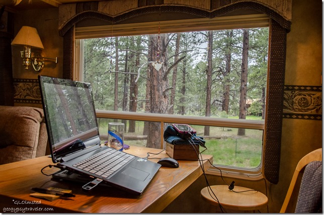 Laptop on table & forest view North Rim Grand Canyon National Park Arizona
