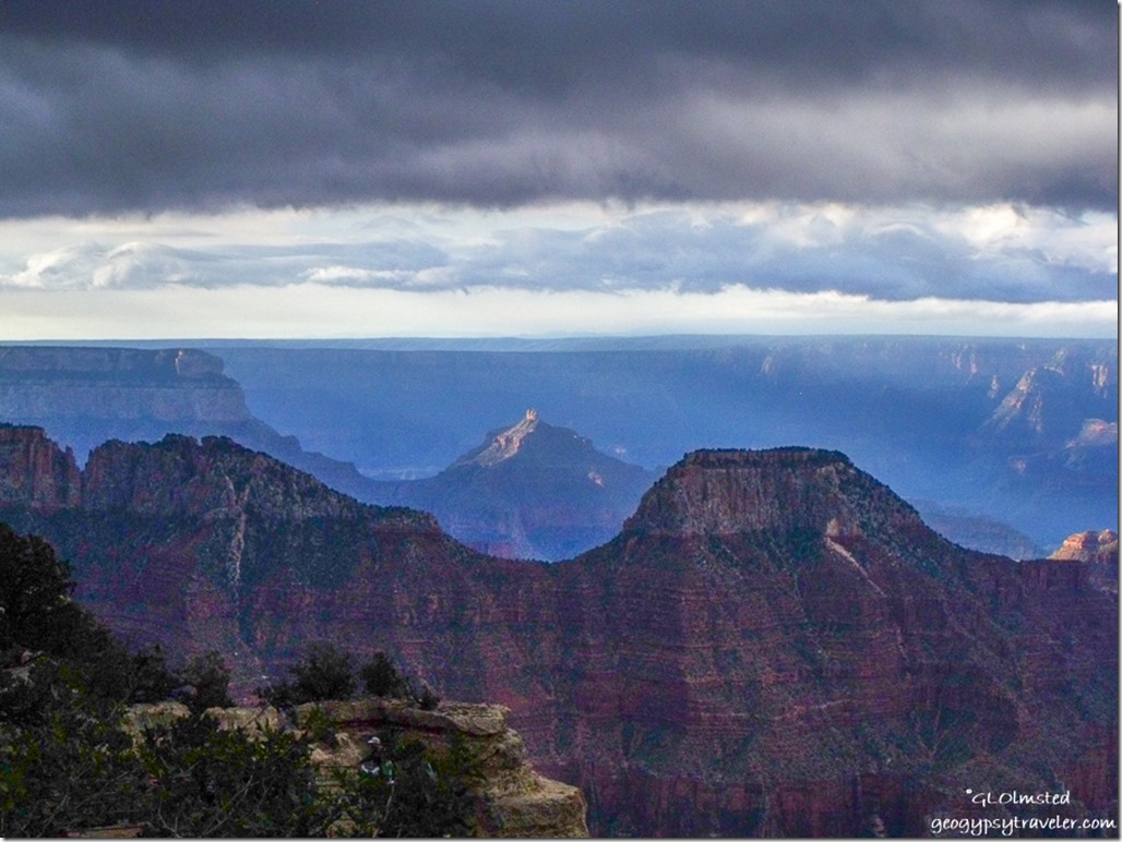 dark sky over morning sunlit temples from Lodge North Rim Grand Canyon National Park Arizona