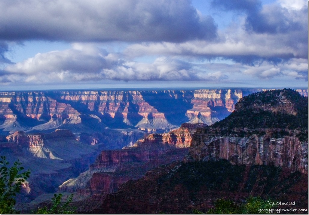 Dark sky over morning sunlit canyon from Lodge North Rim Grand Canyon National Park Arizona