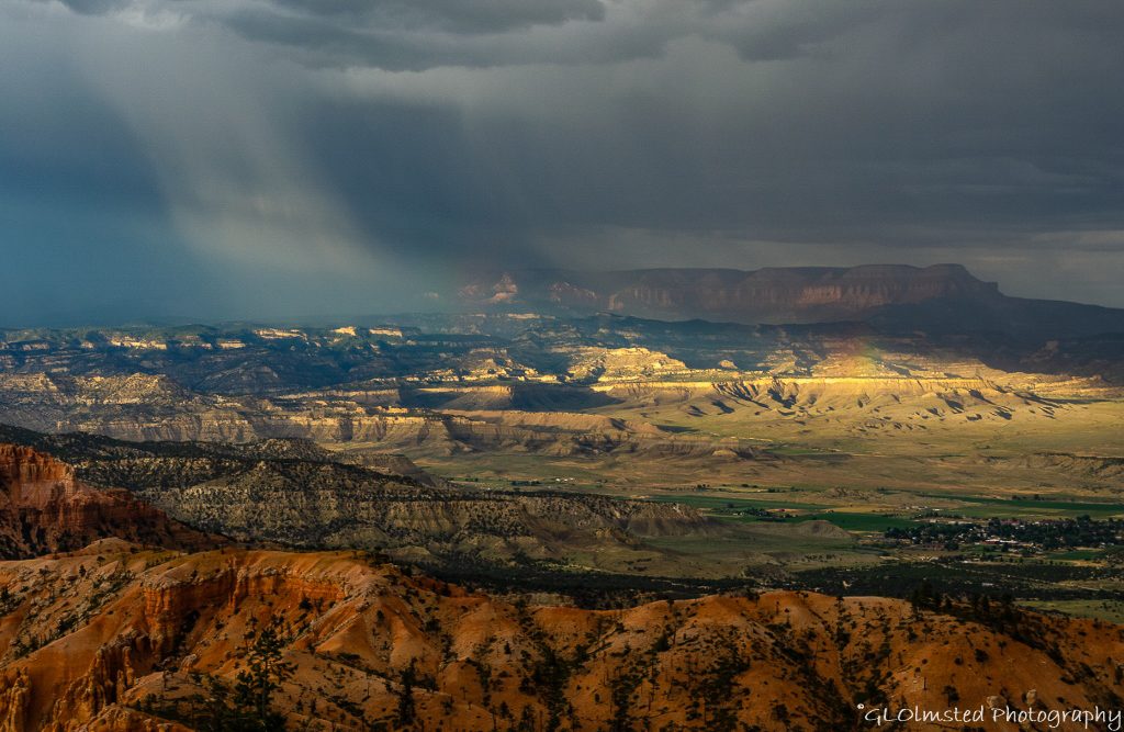 red hills Tropic valley Blue Cliffs Aquarius Plateau sunrays rainbow storm clouds from Bryce Pt BRCA NP UT