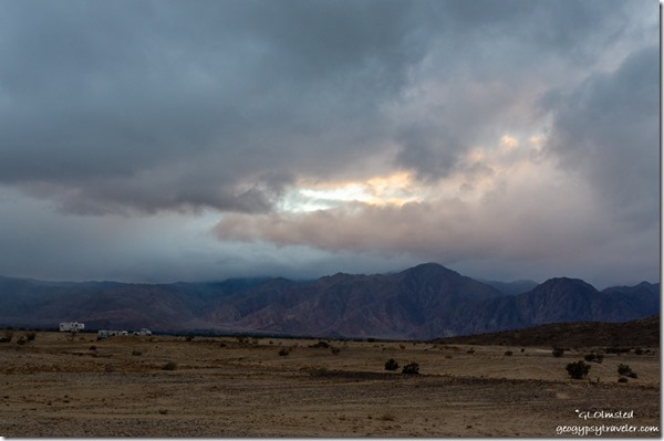Sunset thru storm clouds Vallecito Mountains Anza-Borrego Desert State Park California