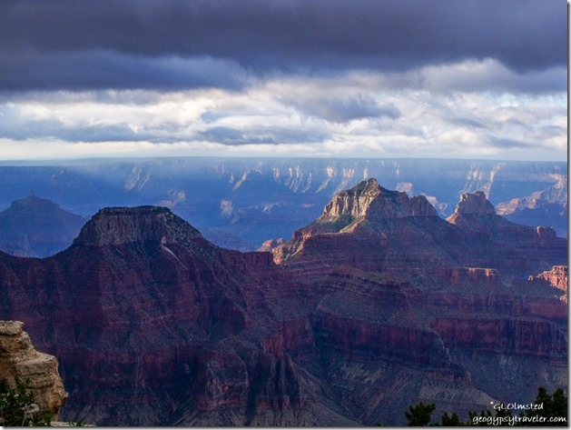 Dark sky over morning sunlit temples from Lodge North Rim Grand Canyon National Park Arizona