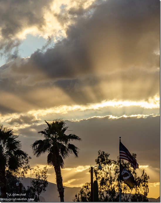 Palm tree flag sunset clouds crepuscular rays Shady Lane RV Park Quartzsite Arizona
