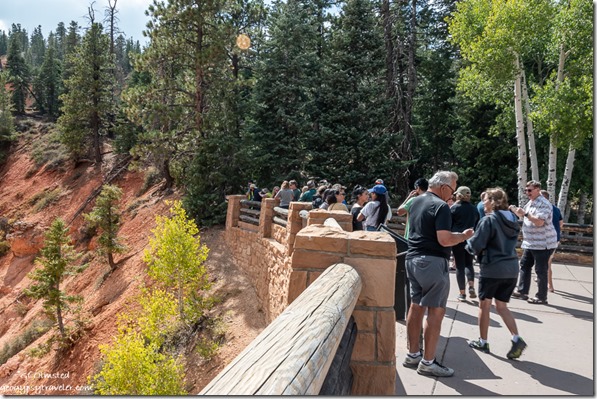 visitors taking selfies Natural Bridge overlook Bryce Canyon National Park Utah