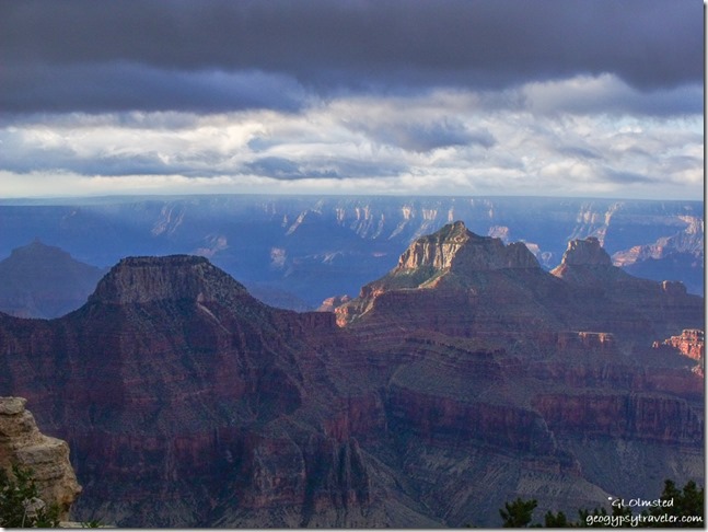 Dark sky over morning sunlit temples from Lodge North Rim Grand Canyon National Park Arizona