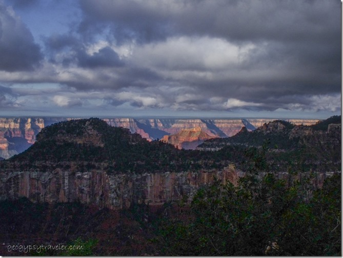 Dark sky over morning sunlit canyon from Lodge North Rim Grand Canyon National Park Arizona