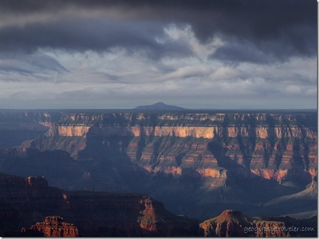 Dark sky over morning sunlit canyon from Lodge North Rim Grand Canyon National Park Arizona