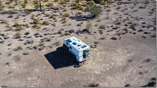 drone shot Gaelyn at truckcamper door BLM Palm Canyon Rd Kofa National Wildlife Refuge Arizona by Bob