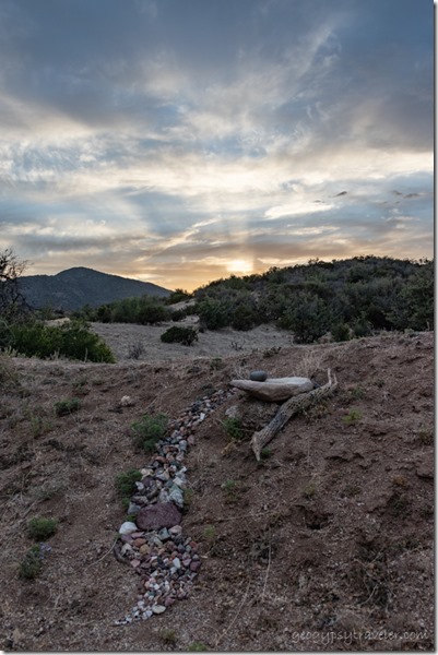 rocks berm grass trees Brushy Mt sunset clouds crepuscular rays Skull Valley AZ