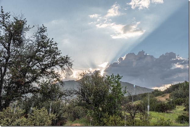 raining Brushy Mt clouds sun setting crepuscular rays Skull Valley AZ